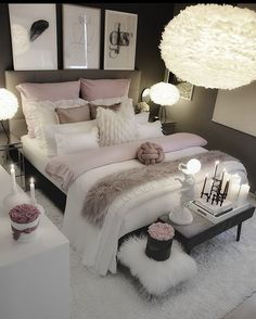 a bedroom with white and pink decor on the walls, carpeted flooring and bedding