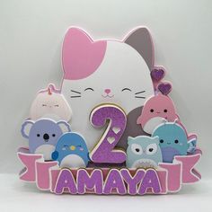 an animal themed birthday card with the number two in pink, blue, and purple