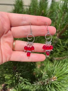 Faceted red glass beads on a silver spiral shape. 3 separate dangles. On a hook hypoallergenic earring. Red Czech Glass Beaded Earrings With Dangling Beads, Red Wire Wrapped Dangle Earrings, Red Spiral Jewelry As Gift, Red Spiral Jewelry For Gifts, Spiral Shaped Red Jewelry For Gifts, Red Sterling Silver Beaded Earrings, Nickel-free Red Beaded Sterling Silver Earrings, Red Sterling Silver Nickel-free Beaded Earrings, Adjustable Red Spiral Jewelry