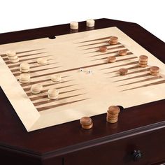 a wooden board game set with several stacks of coins sitting on top of the board