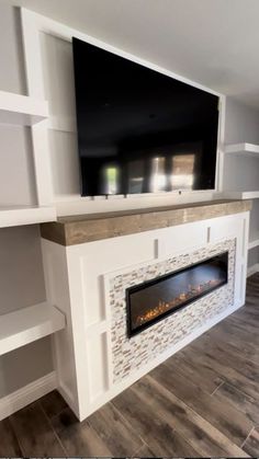 a large flat screen tv mounted above a fireplace