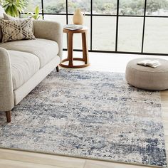 a living room with a couch, chair and rug