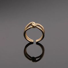 a gold ring sitting on top of a black surface