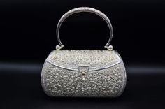 Incredible Solid Silver handbag hand embossed and pierced throughout. The bag has a silver handle and silver closure. It is marked and tested as silver. Exquisitely finished floral motif throughout. Each piece has been hand selected and meticulously identified and graded by a Graduate Gemologist who has been awarded a degree by the Gemological Institute of America (GIA). Please visit our Shop's About Page or our website for more information about our jewelry. If you have any questions about this Luxury Shoulder Bag With Silver-tone Hardware As Gift, Designer Silver Shoulder Bag Gift, Designer Silver Shoulder Bag As Gift, Silver Luxury Clutch Shoulder Bag, Luxury Silver Clutch Shoulder Bag, Luxury Silver Shoulder Bag With Detachable Handle, Luxury Silver Clutch Bag, Designer Silver Shoulder Bag With Detachable Handle, Classic Silver Rectangular Shoulder Bag