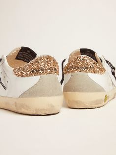 Young white leather Super-Star sneakers with glittery heel tab | Golden Goose Gold Low-top Sneakers With Glitter Accents, White Leather Sneakers With Glitter Accents, Golden Family, Star Sneakers, Gold Heels, Golden Goose, Inspirational Women, Girls Shopping, Get The Look