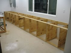 the room is being built with plywood and windows in place for the cabinets to be installed