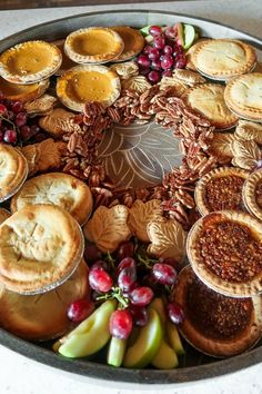 a platter filled with pies and fruit