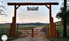 a wooden gate with a sign that says harris ranch on it's top and an open field in the background