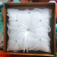 a box with a ring pillow in it