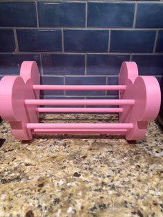 a pink toy bench sitting on top of a counter