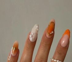 three different manies with orange and white designs on each one nail polishing the other