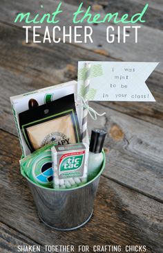 a bucket filled with teacher gift items sitting on top of a wooden table