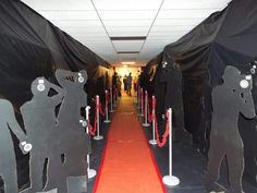 the hallway is lined with black paper cutouts and red carpet