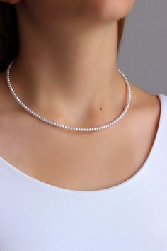 Simple, delicate and lightweight beaded choker necklace with tiny pearl coated plastic 3 mm beads, strong double nylon thread, silver tone clasps, silver tone lobster clasp and stainless steel adjustable length chain. Perfect for everyday wear or a pretty gift for someone special! You can wearing it with other chokers, chain necklaces or alone! Total length of necklace is about 42.5-43 cm or about 16.9 inches and 5 cm of adjustable length chain. Other necklaces of my shop you can see here: https Adjustable Tiny Beads Pearl Necklace, Pearl Necklace With Tiny Round Beads, Pearl Choker With Tiny Beads, Classic Beaded Choker Necklace, Dainty Pearl Choker With Round Beads, Elegant White Choker With Tiny Beads, White Tiny Beads Pearl Choker Necklace, White Tiny Beaded Pearl Choker, White Pearl Choker With Tiny Beads