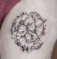 a woman's thigh with a cat and dog tattoo on it