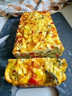 two slices of quiche sitting on top of a cutting board