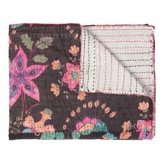 the brown and pink floral pocket square is folded on top of each other, with a white