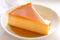 a piece of cheesecake on a white plate with caramel sauce in the center