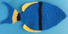 a crocheted blue and yellow fish on a blue background