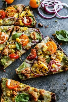 several slices of vegetable pizza on a table