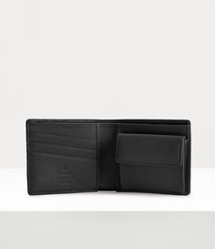 Our Man. Wallet features an smooth leather design, complete with the house's signature 'Orborama' embossing, showcasing interconnected raised orb details in an all-over pattern. The piece receives a snap-fastening coin pocket with three integrated card slots, finished with a dedicated compartment for receipts and notes. Black Vivienne Westwood, Wallet With Coin Pocket, Luxury Wallet, Press Studs, Mens Swimwear, Leather Design, Lace Boots, Vivienne Westwood, Lace Up Shoes