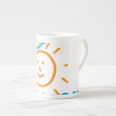 a coffee mug with a drawing of a smiling sun on the front and back of it