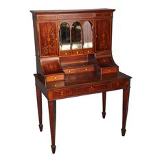 an antique wooden desk with mirror and drawers