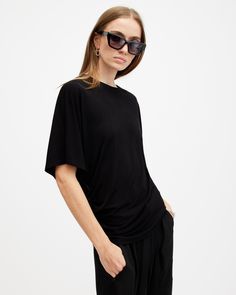 Looking for elevated essentials? We've got you. The Kali is new in this season. Crafted from recycled fabrics with a little bit of stretch, it's relaxed fitting with short batwing sleeves. There's gathering on the seams to create a flattering drape on the body. Tuck into tailored pants or keep it casual paired with wide-leg jeans.  This t-shirt is designed to a relaxed fit Crew neck Short sleeves Batwing sleeves Essential shape Gathered side seams Allsaints Relaxed Fit Tops For Spring, Allsaints Relaxed Fit Spring Tops, Allsaints Short Sleeve Tops With Relaxed Fit, Allsaints Relaxed Fit Short Sleeve Tops, Allsaints Short Sleeve Tops For Summer, Allsaints Crew Neck Top For Everyday, Casual Oversized Tops By Allsaints, Allsaints Everyday Crew Neck Top, Oversized Allsaints Casual Tops