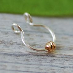 NO PIERCING REQUIRED Gorgeous 14k gold filled bead (3 mm) on silver sterling / 14k gold filled septum ring. Please choose gauge: ★Gauge: the thickness of the wire the smaller the gauge the thicker the earring shaft is. 18 gauge - 1 mm (very thick) 20 gauge - 0.8 mm (thick) 22 gauge - 0.6 mm (standart) PLEASE Choose options: 22/20/18 gauge 14k gold filled 22/20/18 MIX - silver hoop with 14k gold filled bead Please choose material: ★100% 14K gold filled ★ ★100% Silver Sterling ★ Inner diameter: 0. Gold Dainty Nose Rings Nickel Free, Dainty Gold Nickel-free Nose Rings, Dainty Gold Nose Rings Nickel Free, Dainty Adjustable Tiny Nose Rings, Tiny Gold Septum Ring As Gift, Tiny Gold Septum Ring Gift, Adjustable Gold Stackable Septum Ring, Dainty Tiny Adjustable Nose Rings, Adjustable Gold Sterling Silver Septum Ring