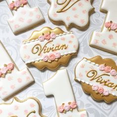 decorated cookies are arranged in the shape of letters and numbers with pink flowers on them