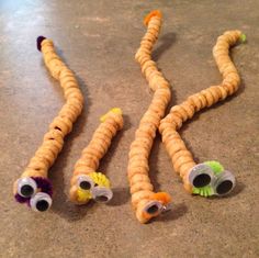 some kind of snake made out of crackers and other items that are on the ground