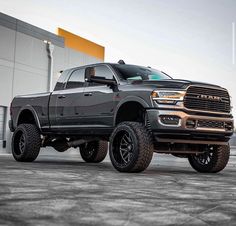 a large gray truck parked in front of a building