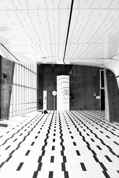 an empty room with black and white checkered tiles on the floor, walls and ceiling