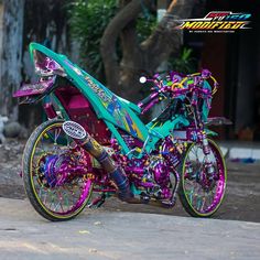 a purple and green motorcycle parked on the street