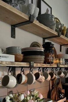 pots and pans are hanging on the shelves