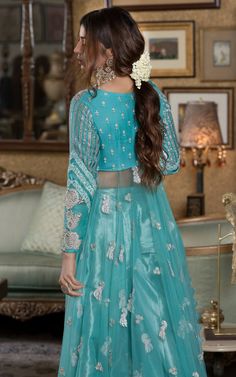 Verdigris full-sleeved Pishwas in chiffon with a leaf neckline, paired with a matching tissue sharara. Discover long Anarkali dresses, festive Anarkali suits, and elegant options for bridesmaids.Witness the enchanting beauty of the verdigris festive ensemble, a visual symphony that resonates with the soul and dances to a captivating folk melody. Adorned with intricate silver embellishments, this attire breathes life into the essence of tradition, exuding an exquisite charm that captivates the be Frock Pakistani, Tissue Sharara, Bridal Frock, Long Anarkali Dress, Pakistani Bridal Dress, Anarkali Dresses, Ice Blue Color, Long Anarkali, Pakistani Dresses Online