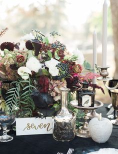 a table topped with lots of flowers and candles