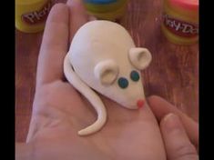 a hand holding a toy mouse in it's palm