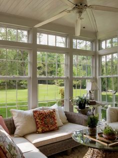 a living room filled with furniture and lots of windows