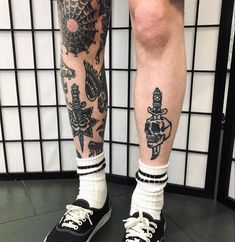 the legs and ankles of a man with tattoos