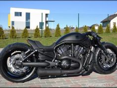 a black motorcycle parked in front of a house