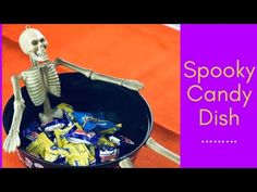 a skeleton is sitting in a bowl full of candy and the words spooky candy dish