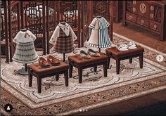 a group of dolls sitting on top of a rug in front of a wooden table