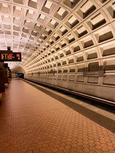 an empty subway station with no people on the platform