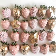 chocolate covered strawberries are arranged in the shape of hearts and swirls on a white surface