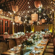 a long table is set up with flowers and place settings for an elegant dinner party