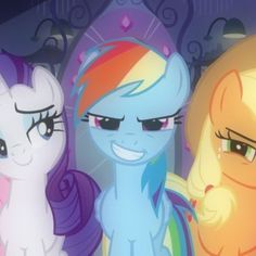 three different colored ponies standing next to each other