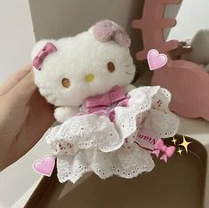 a hello kitty stuffed animal in a white dress