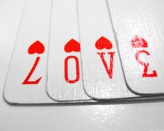 four playing cards with the word love printed on them