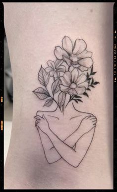 a woman's leg with flowers on it